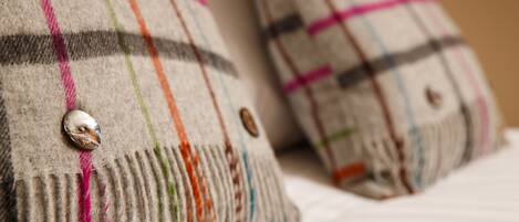 Two pillows with a plaid pattern and buttons.