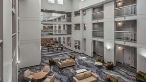 A spacious lobby with multiple seating areas, a central coffee table, and a marble-patterned floor. - Fairfield Inn & Suites by Marriott Oakland Hayward (Hayward)