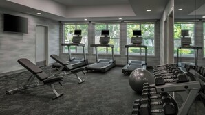 A modern gym with exercise equipment, large windows, and a flat-screen TV. - Fairfield Inn & Suites by Marriott Oakland Hayward (Hayward)
