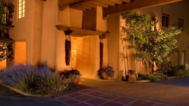 A modern building with a covered patio area, large windows, and a well-maintained garden. - The Hacienda & Spa at Hotel Santa Fe (Santa Fe)
