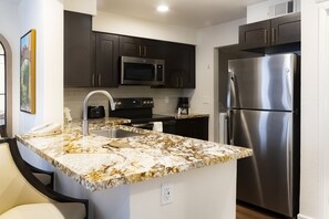 Deluxe Villa, 1 Bedroom | Private kitchen | Fridge, oven, coffee/tea maker, cookware/dishes/utensils - Westgate Flamingo Bay Resort (Las Vegas)