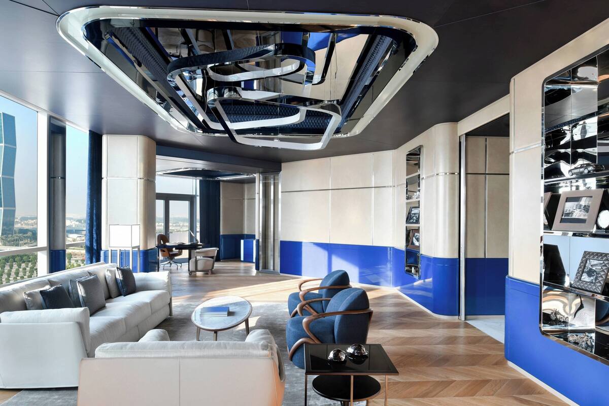 A modern lounge area with a sofa, chairs, and a coffee table.