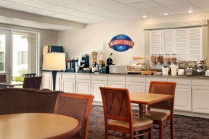 Enjoy a delicious breakfast at our breakfast area, where guests can sit at tables and chairs to enjoy a variety of breakfast items and freshly brewed coffee.