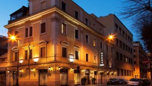 A historic building with multiple stories, large windows, and a classic architectural style.