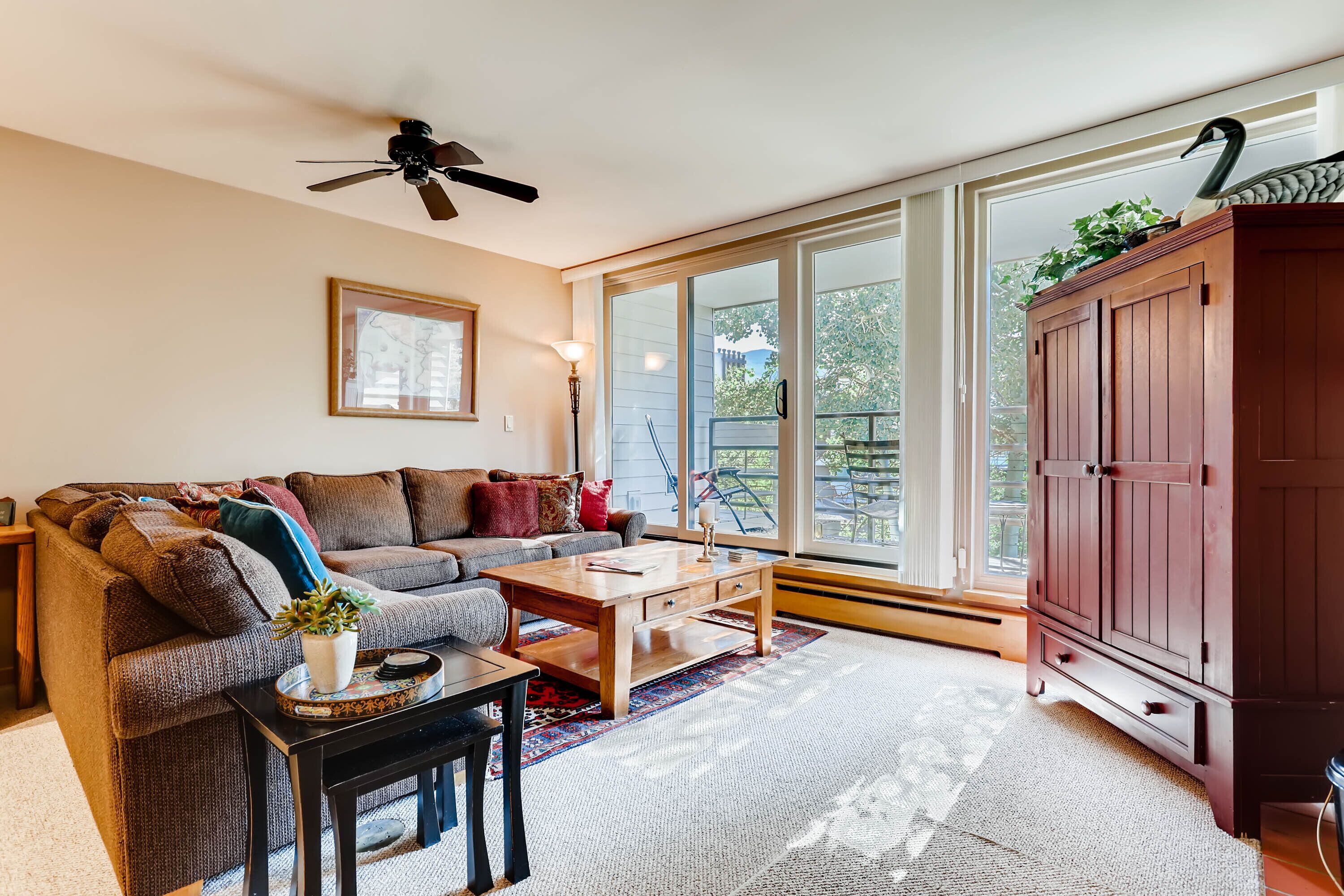 A living room with a sofa, coffee table, and a cabinet.