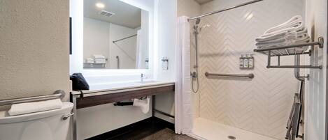 Une salle de bain moderne équipée d’une douche, de toilettes et d’un lavabo.