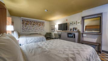 A hotel room with two beds, a television, a coffee maker, and a microwave.
