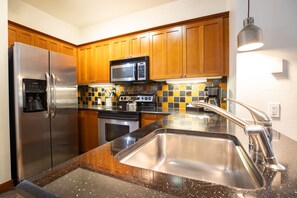 One Bedroom Condo - Plus Den | Private kitchen | Coffee/tea maker, highchair