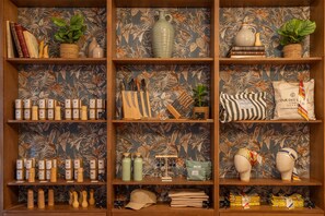 A wooden shelf with various items including books, vases, and decorative objects.