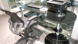 A modern office desk with a computer, keyboard, mouse, and printer. - Grant Plaza Hotel (San Francisco)