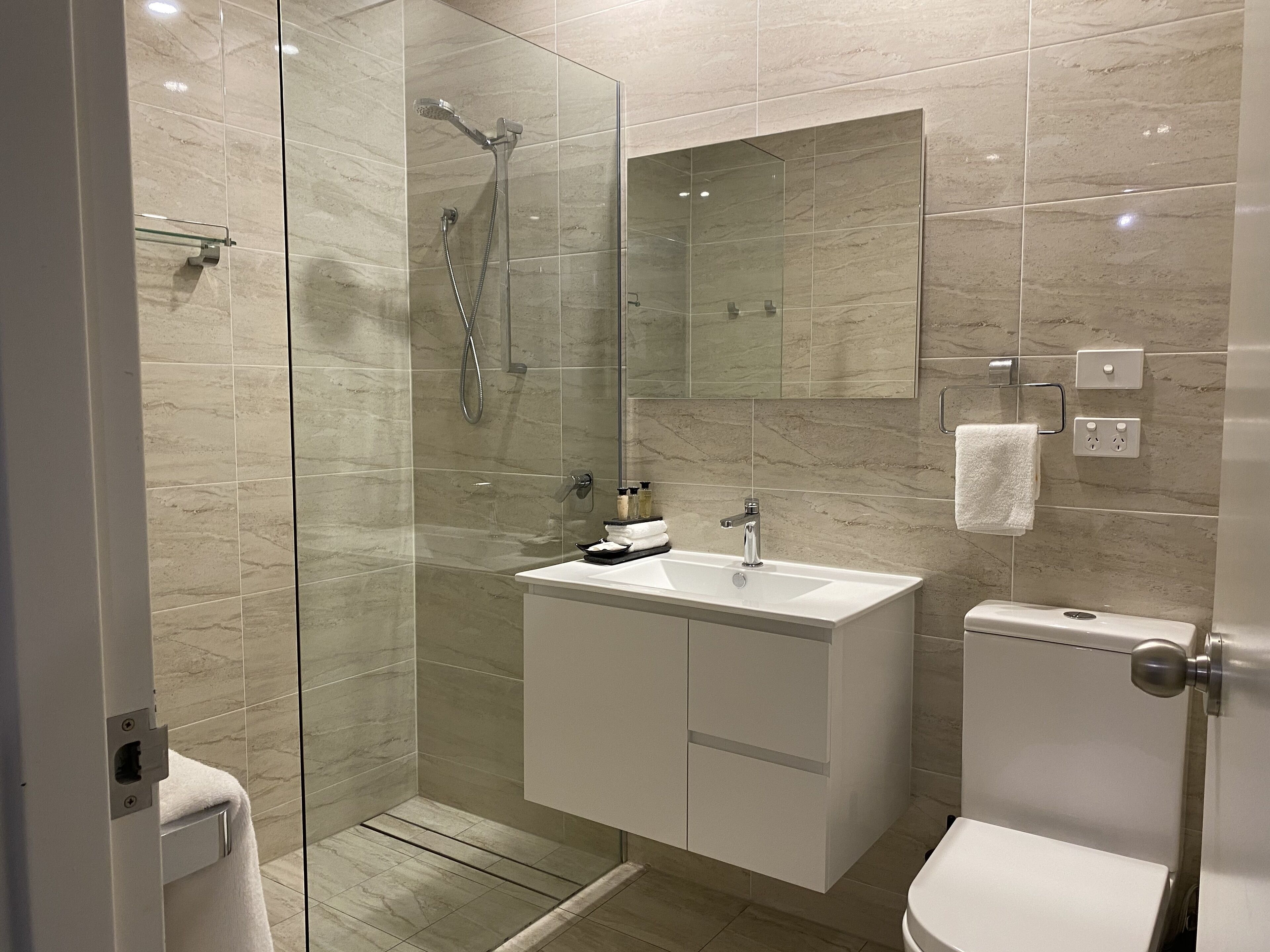 two bedroom deluxe | bathroom | combined shower/bathtub, free toiletries, hair dryer, slippers