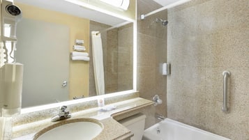 A bathroom with a sink, mirror, towel rack, shower, and bathtub.