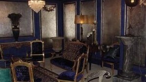 A room with a patterned carpet, a chandelier, and a statue. - The Pavilion Hotel (London)