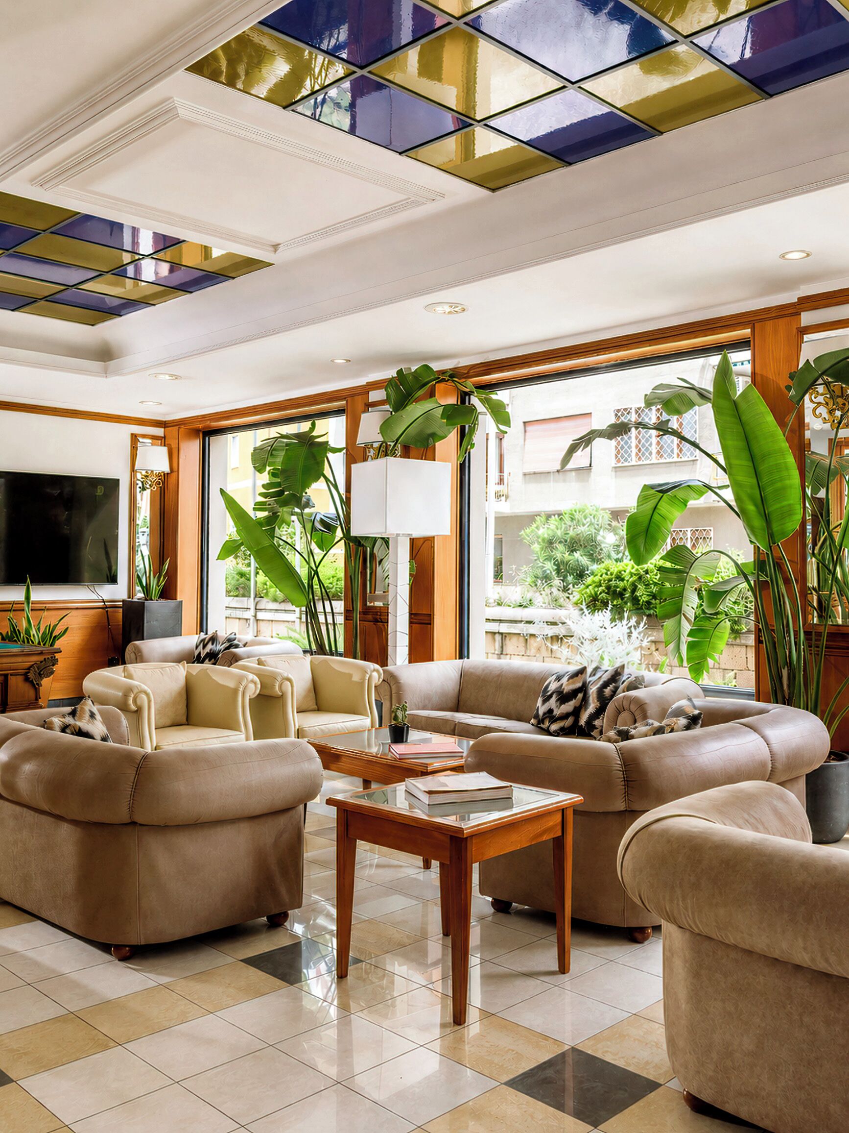 A spacious living room with a large sofa set, a coffee table, and a television.
