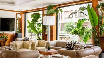 A spacious living room with a large sofa set, a coffee table, and a television.