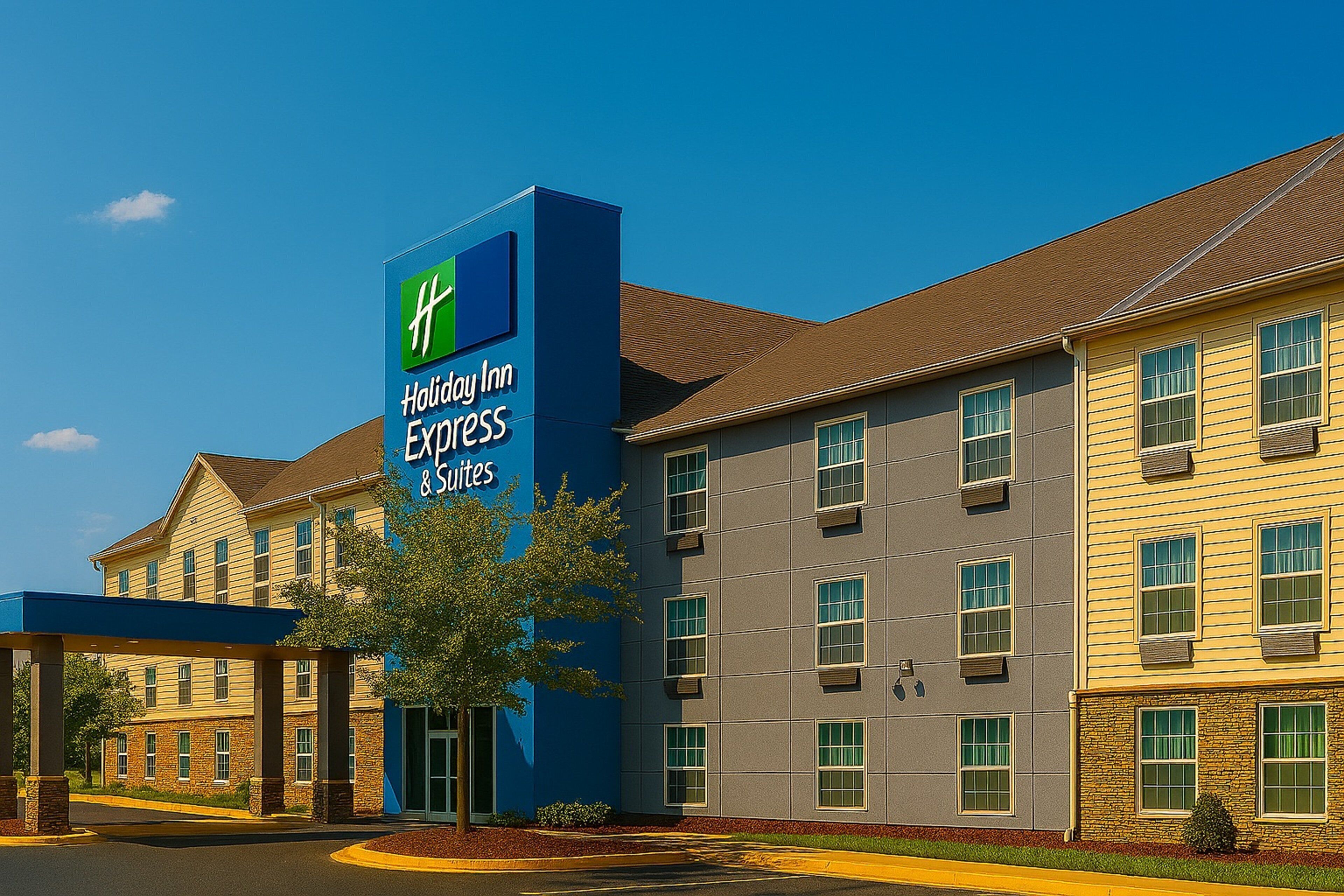 A Holiday Inn Express building with a blue and yellow facade, multiple windows, and a covered entrance area.