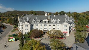 A large, multi-story building with a symmetrical facade, multiple chimneys, and a central entrance. - Holiday Inn Express and Suites Tremblant by IHG (Mont-Tremblant)
