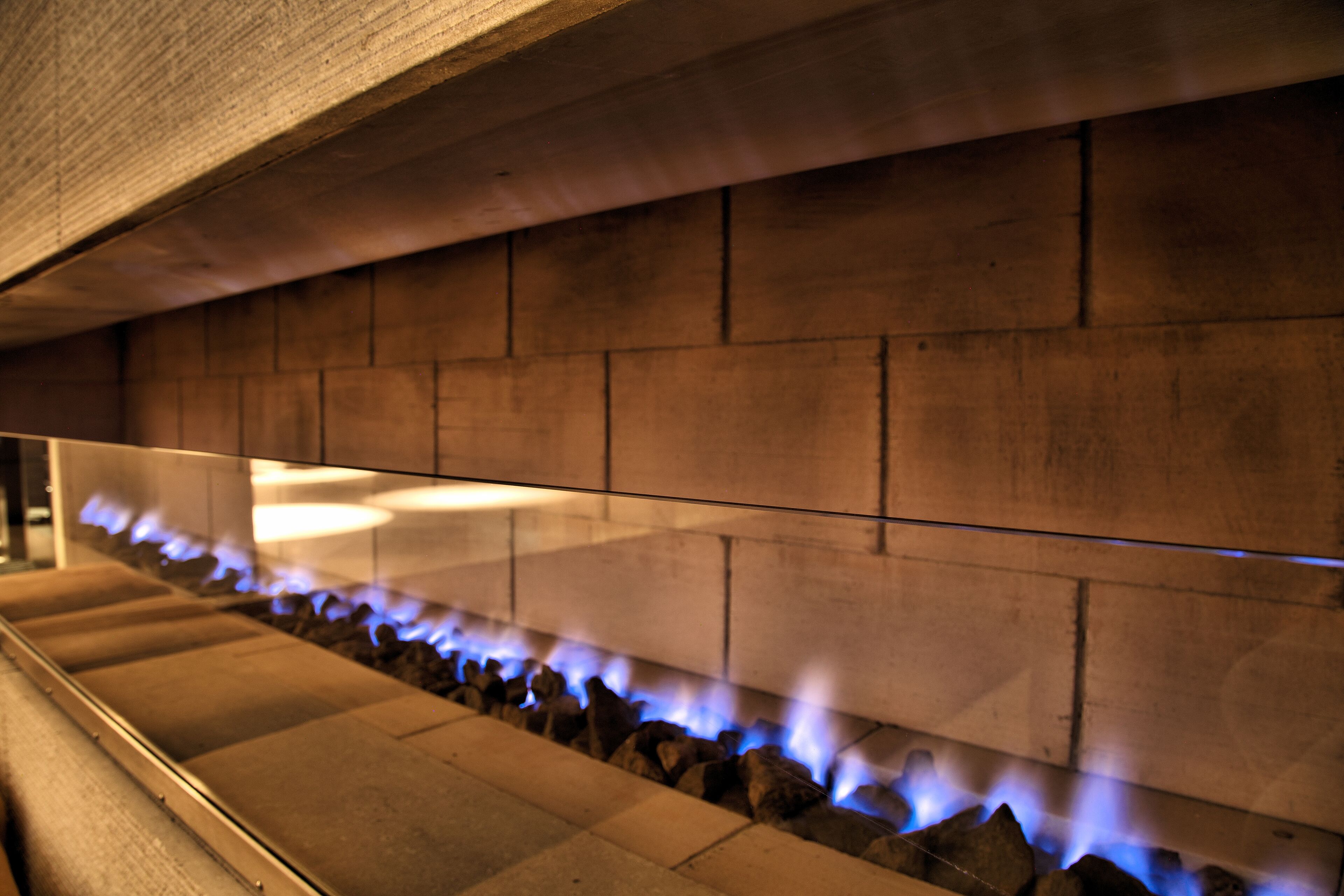 A stone wall with a fire feature running along its length.