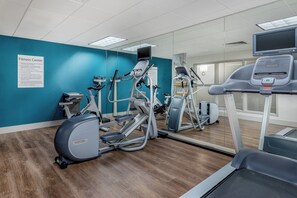 A fitness center with various exercise equipment, including treadmills and stationary bikes, and a mirrored wall. - Holiday Inn Express Chapel Hill by IHG (Chapel Hill)