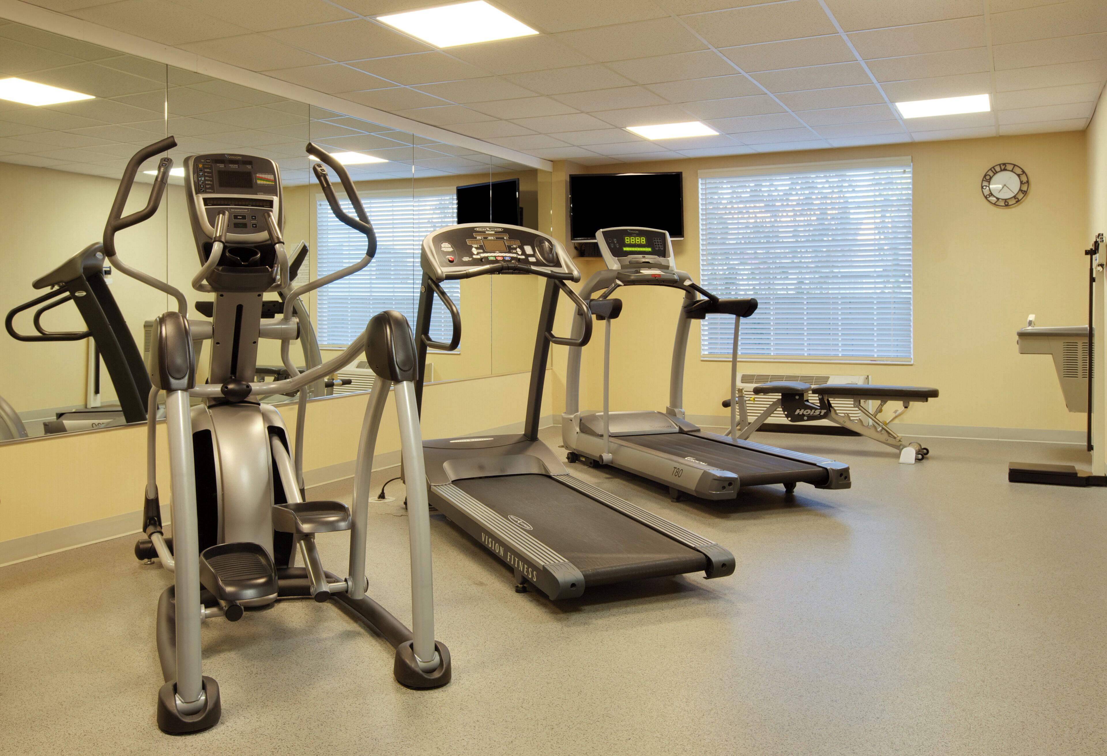 A fitness center with treadmills, elliptical machines, and a stationary bike.