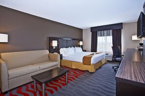 A hotel room with a bed, a sofa, a desk, and a television. - Holiday Inn Express Hotel & Suites Columbus-Groveport by IHG (Groveport)