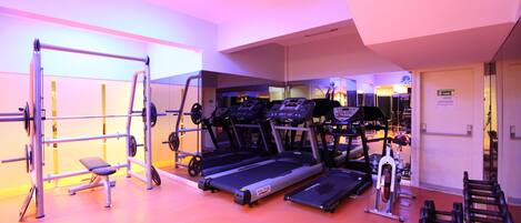 A gym with treadmills, weight machines, and free weights.