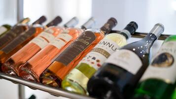A rack of wine bottles with labels indicating different varieties and regions.