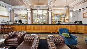 A spacious lobby with a bar area, leather seating, and a large decorative window. - Castlereagh Boutique Hotel, an Ascend Collection Hotel (Sydney)