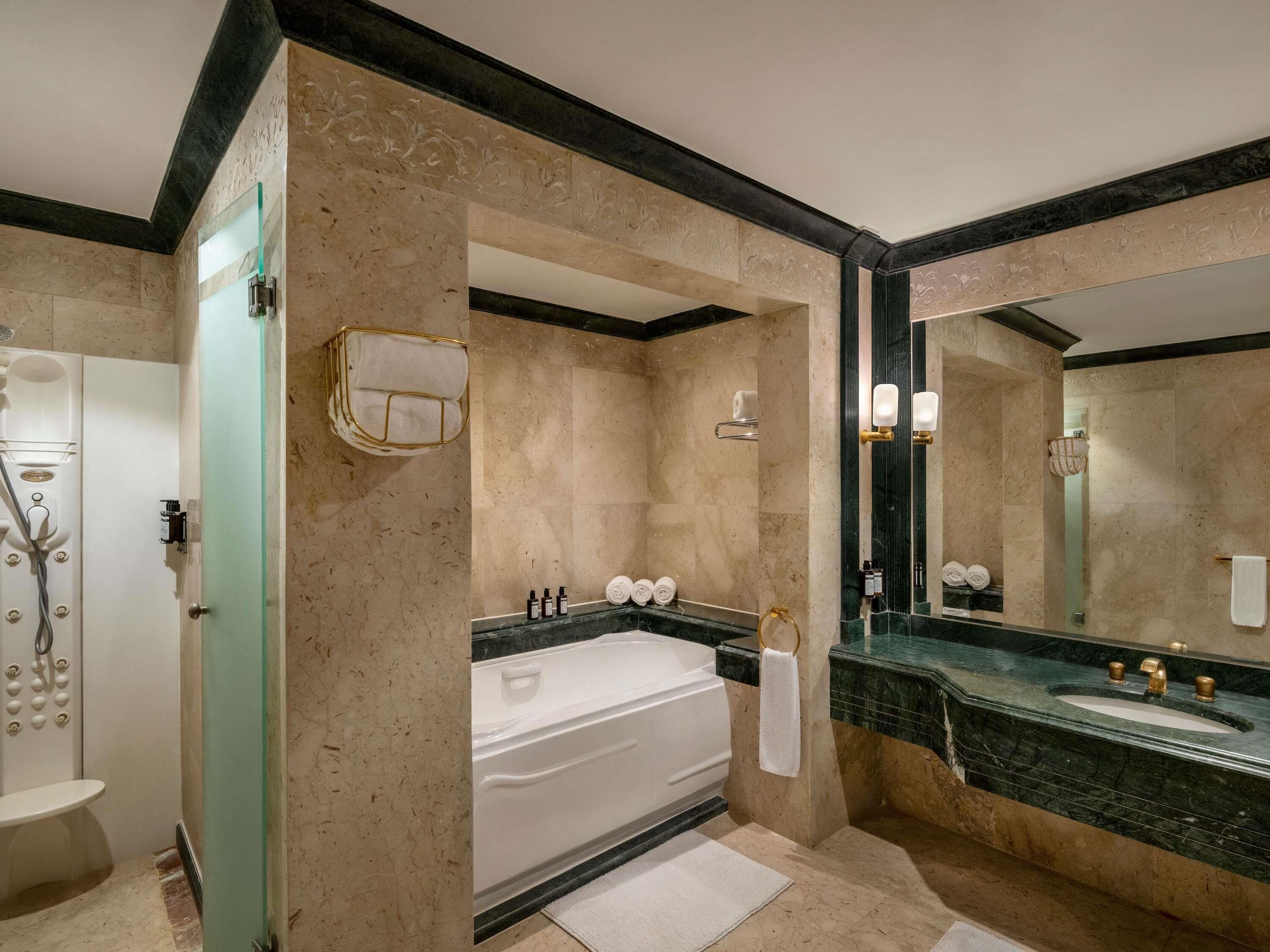 A bathroom with a bathtub, a sink, and a shower.