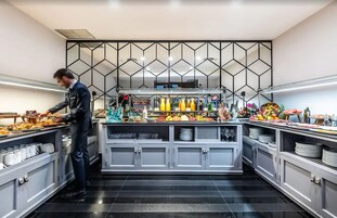 A buffet setup with various food items and beverages.
