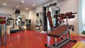 A gym with exercise equipment, a bench, and a treadmill. - Hotel Ariston (Rome)