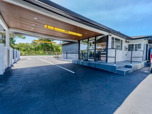A modern gas station with a covered canopy, a concrete structure, and a clear sky. - Monterey Surf Inn (Monterey)