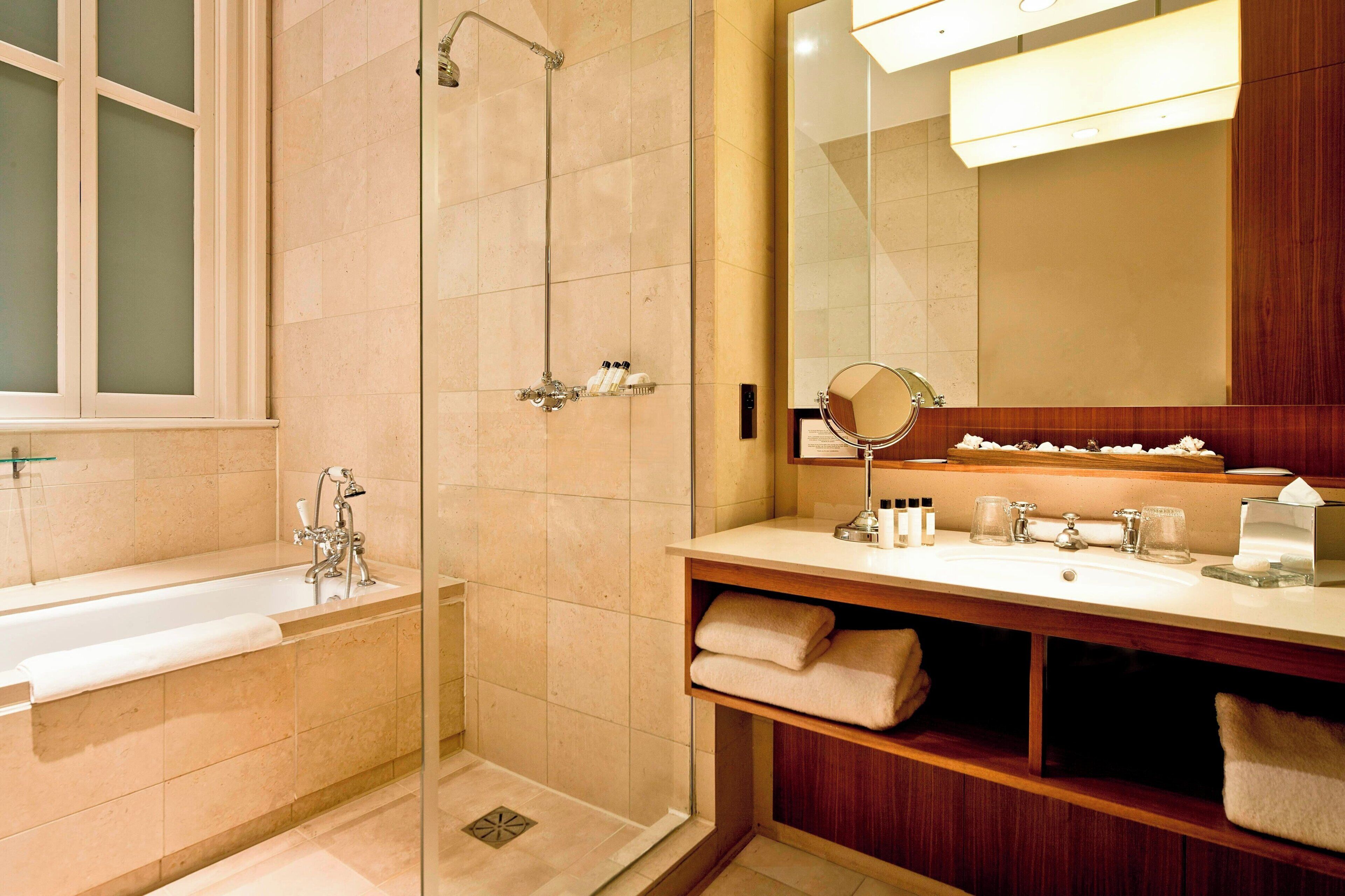 deluxe room, 1 queen bed | bathroom | combined shower/bathtub, designer toiletries, hair dryer, bathrobes
