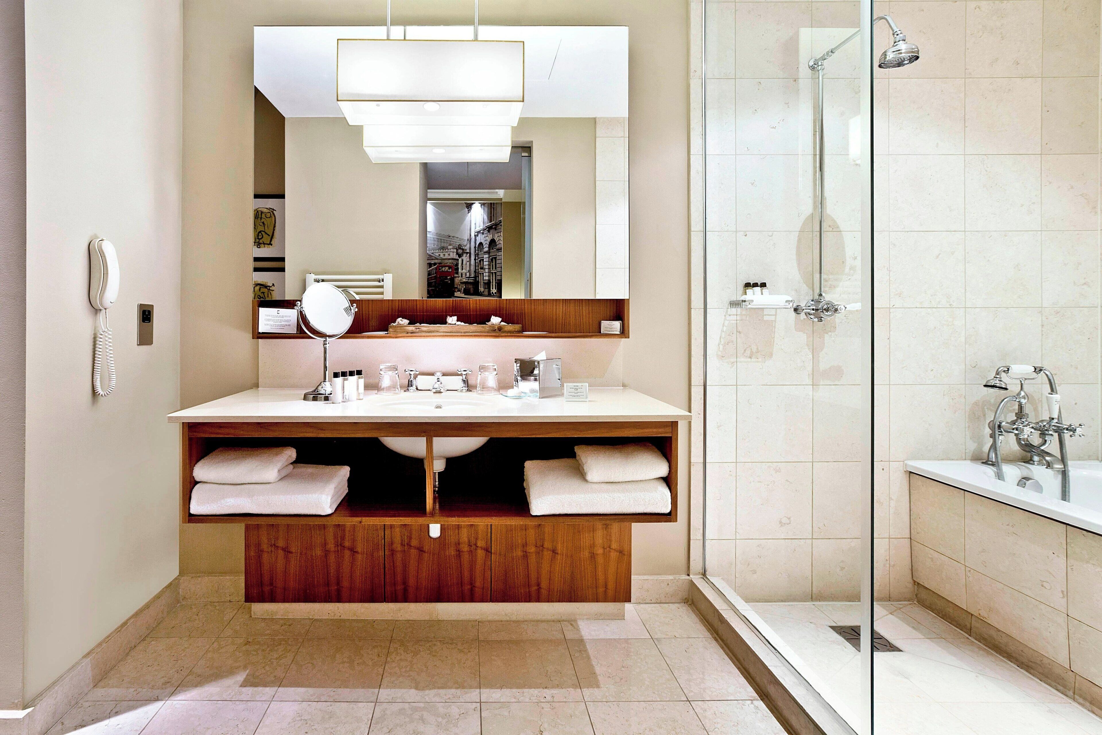 combined shower/bathtub, designer toiletries, hair dryer, bathrobes