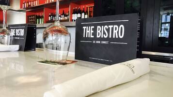 A bar area with a sign reading "THE BISTRO" and a menu board.