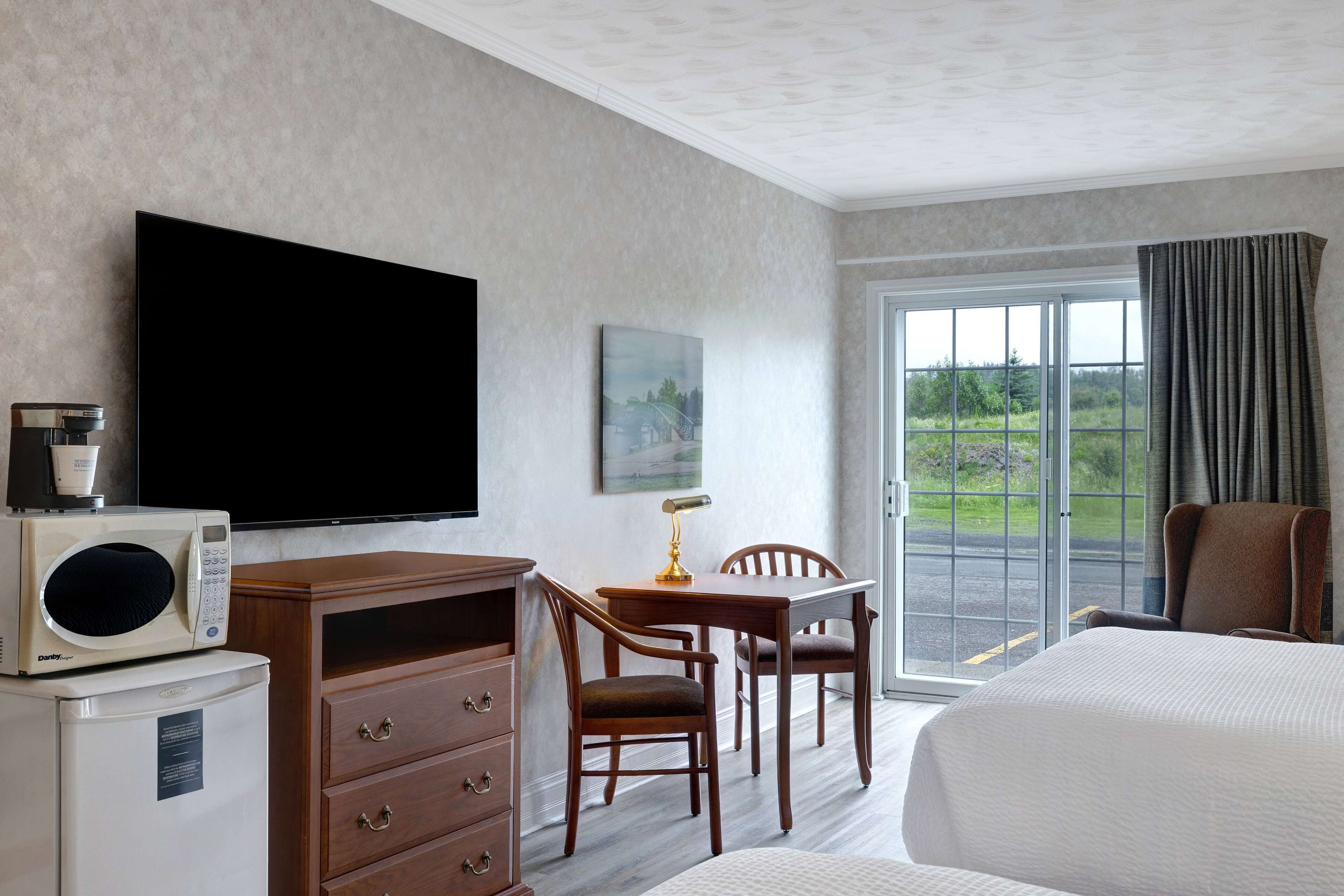 deluxe room, 2 queen beds, non smoking | desk, iron/ironing board, free cots/infant beds, rollaway beds