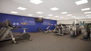 A gym with exercise equipment, motivational wall text, and a large screen. - Holiday Inn Express And Suites Seattle Downtown - Lake Union by IHG (Seattle)