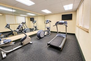 A gym with treadmills, elliptical machines, and a mirrored wall. - Days Inn & Suites by Wyndham Houston North/Aldine (Houston)