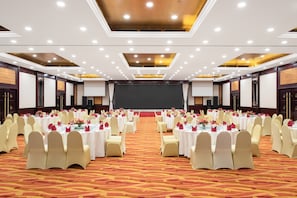 A large conference room with multiple round tables, white tablecloths, and beige chairs. - Holiday Inn Beijing Chang An West by IHG (Beijing)