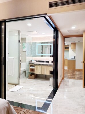 A modern bathroom with a glass shower enclosure, a large mirror, and a vanity with a sink. - Holiday Inn Beijing Chang An West by IHG (Beijing)
