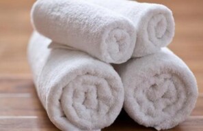Three rolled white towels stacked on top of each other. - Holiday Inn Beijing Chang An West by IHG (Beijing)