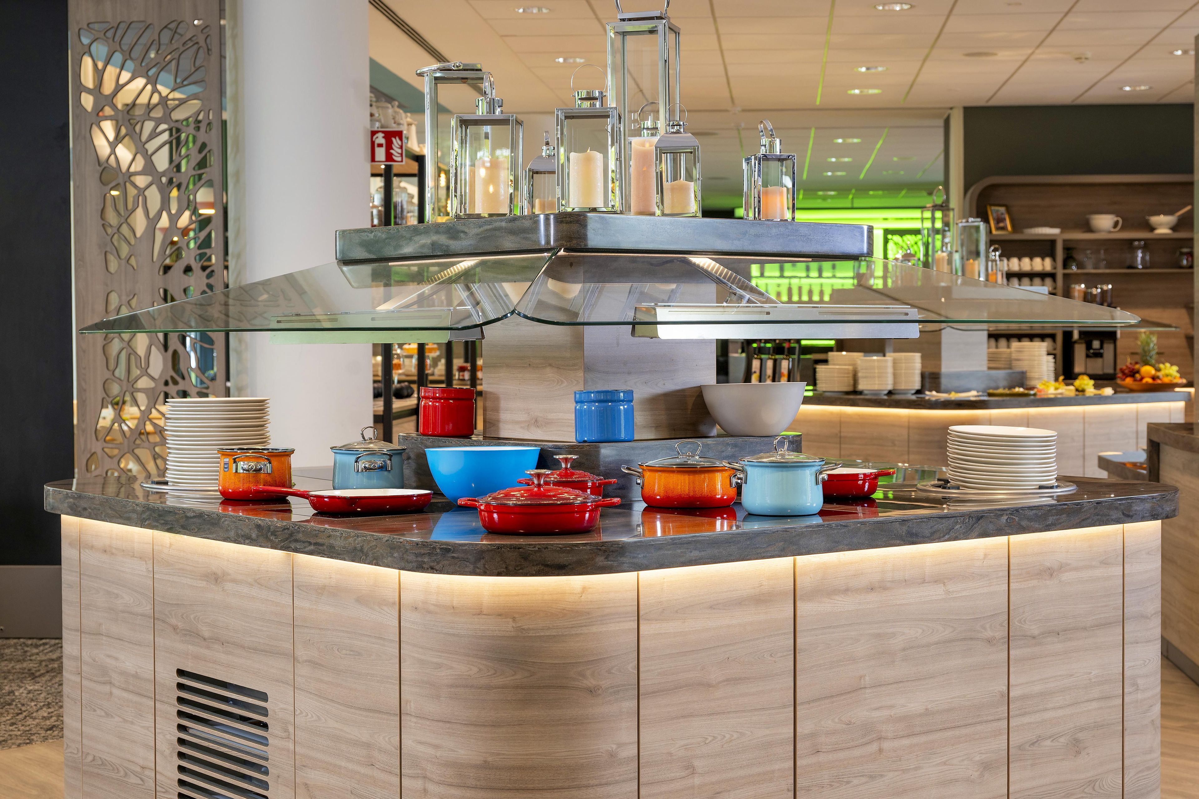 A modern kitchen with a central island, equipped with various cooking utensils and cookware.