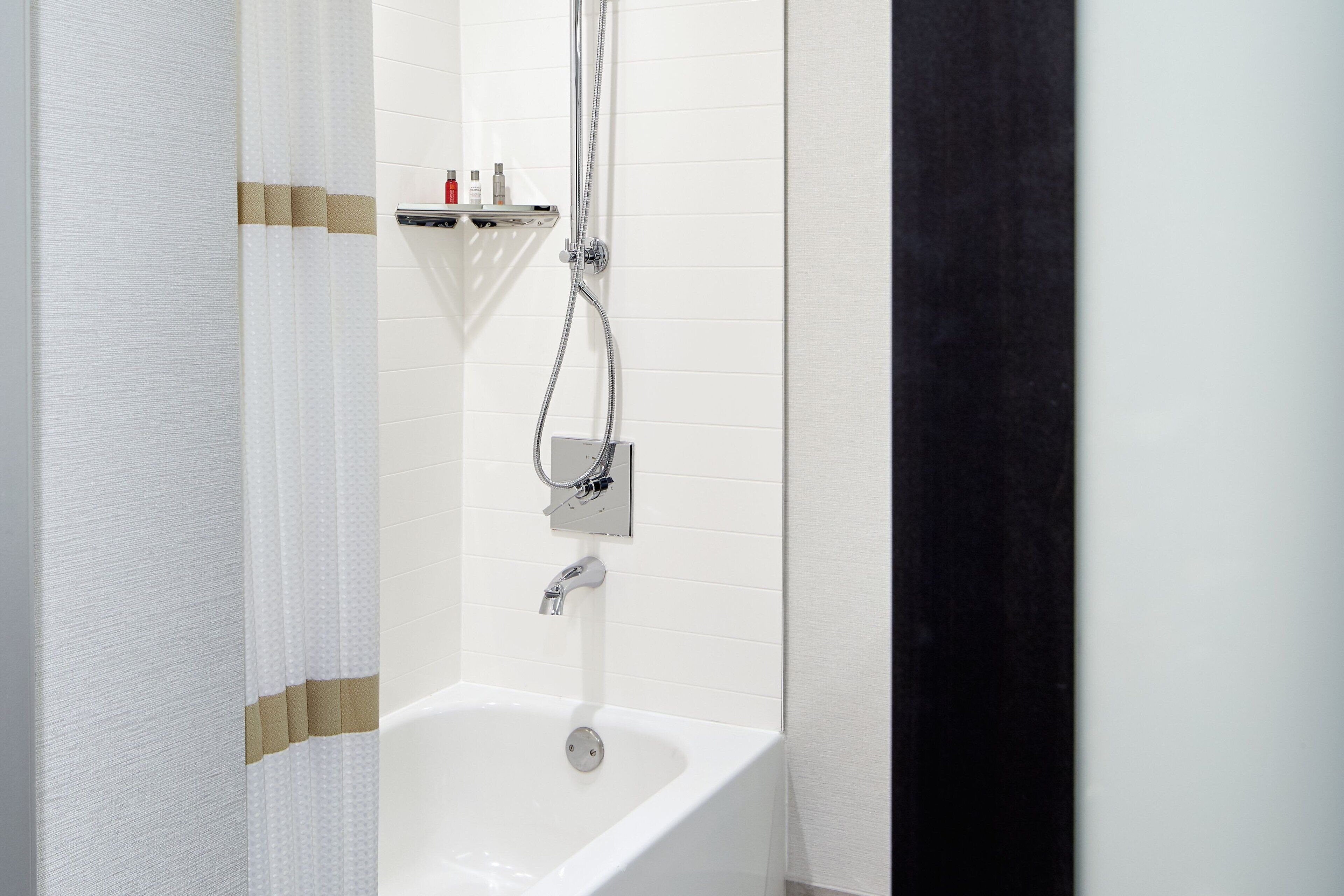 combined shower/bathtub, designer toiletries, hair dryer, towels
