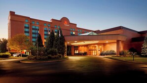 A Marriott hotel with a large entrance, multiple floors, and a well-lit facade.