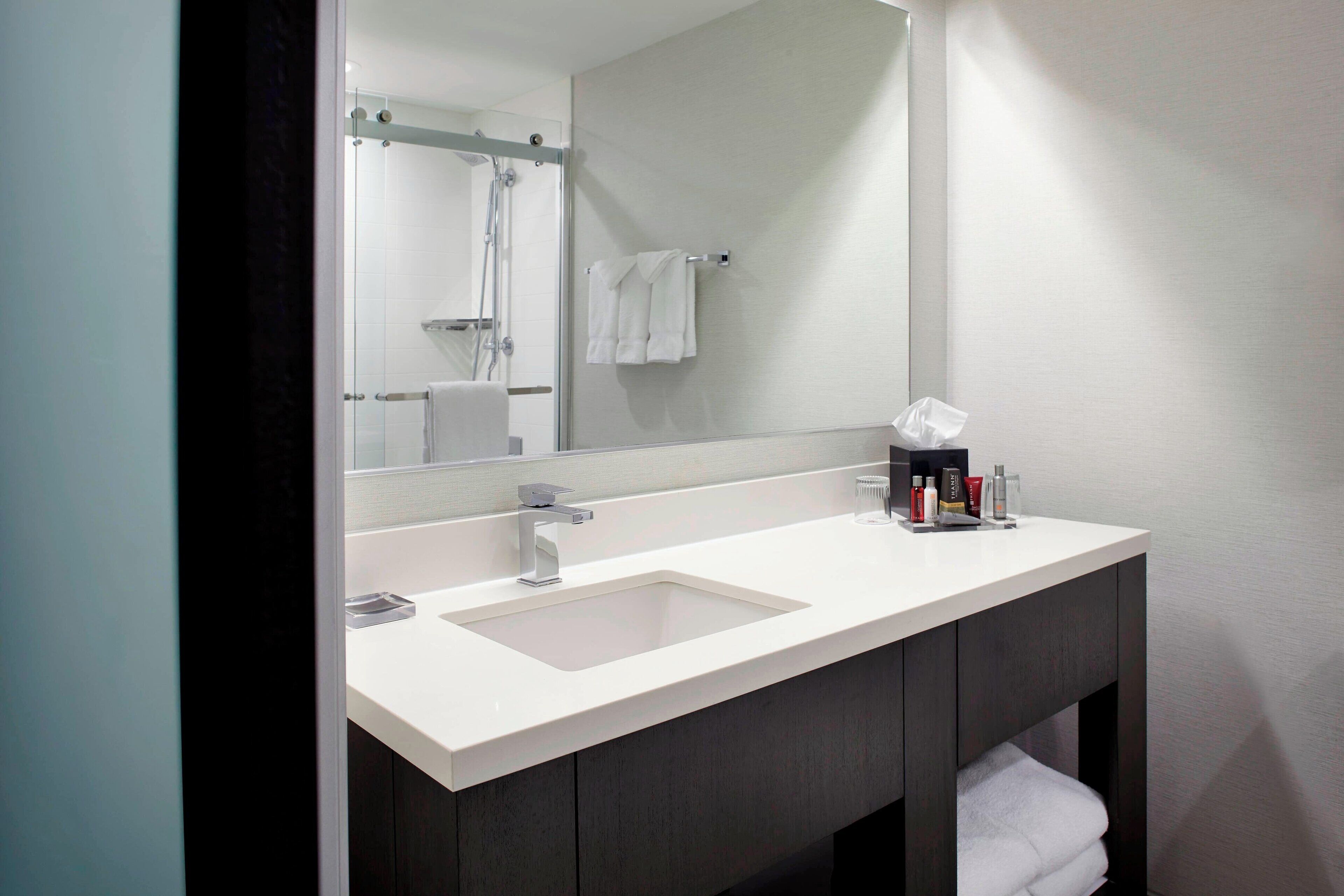 combined shower/bathtub, designer toiletries, hair dryer, towels