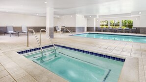 A pool area with two pools, lounge chairs, and a tiled floor. - Residence Inn by Marriott San Jose South\/Morgan Hill (Morgan Hill)