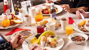 A breakfast setting with various dishes, drinks, and a menu.