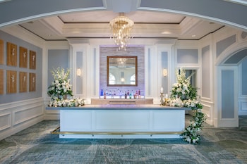 A luxurious lobby with ornate chandeliers, plush seating, and a grand staircase. at The Ritz-Carlton, Sarasota