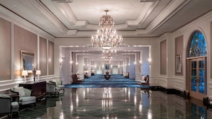 A spacious lobby with a grand chandelier, elegant seating, and a reflective floor. - The Ritz-Carlton, Sarasota (Sarasota)