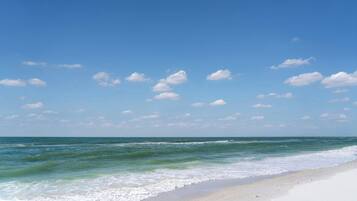 A beach with clear skies and gentle waves.